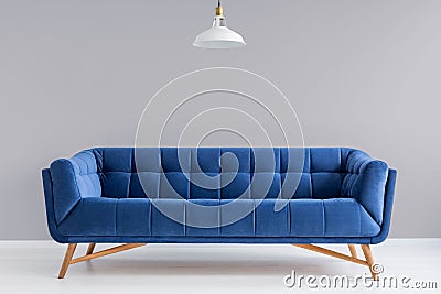 Grey interior with stylish upholstered sofa Stock Photo