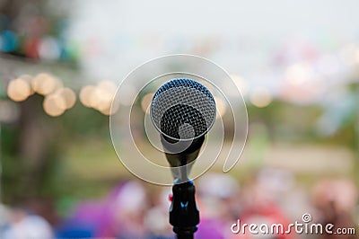 Grey microphone on the stage in bokeh Stock Photo