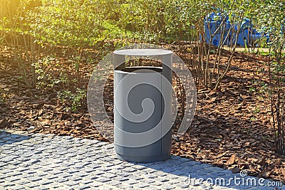grey minimalist dustbin with mulched landscape in city park Stock Photo