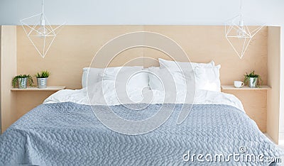 Grey modern bed with wooden bedside Stock Photo