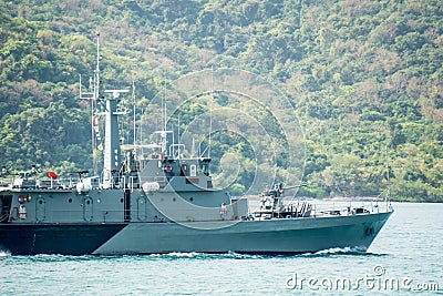 Grey old Navy patrol ship sails in shallow water. Stock Photo