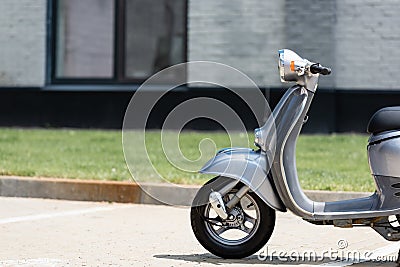 Grey scooter on road near blurred Stock Photo