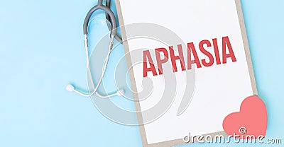 Grey stethoscope and paper plate with a sheet of white paper with text APHASIA light blue backround. Medical concept Stock Photo