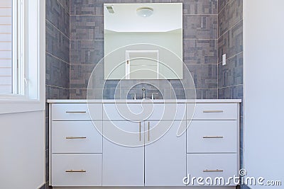 Grey stone pattern tiled contemporary bathroom interior design with minimal natural wood furniture details dominate neutral colors Stock Photo