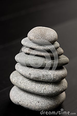 Grey Stones Balanced on the black background Stock Photo