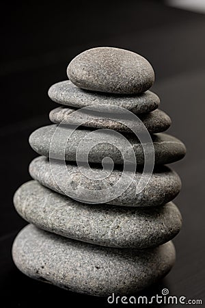 Grey Stones Balanced on the black background Stock Photo