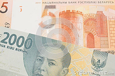 A grey two thousand Indonesian rupiah bank note paired with a orange five ruble bank note from Belarus. Stock Photo