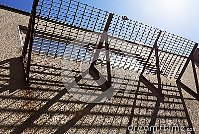 Grid balcony that throws shadows Stock Photo