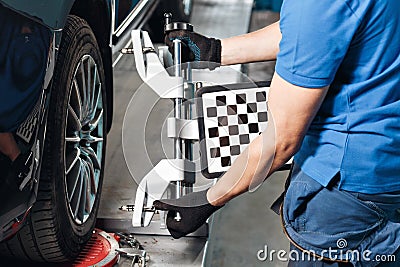 Grid sensor sets mechanic on auto. Car stand with sensors wheels for alignment camber check in workshop of Service Stock Photo