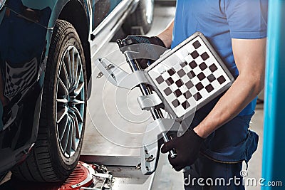 Grid sensor sets mechanic on auto. Car stand with sensors wheels for alignment camber check in workshop of Service Stock Photo