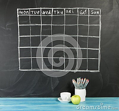 Grid timetable schedule on black chalkboard background. Stock Photo