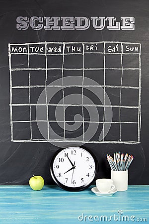 Grid timetable schedule on black chalkboard background. Stock Photo