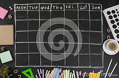 Grid timetable schedule with stationery on black chalkboard back Stock Photo