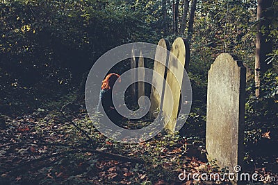 Grieving woman by grave Stock Photo