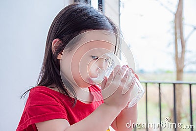 Gril drinking milk from glass Stock Photo