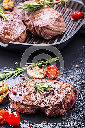 Grill beef steak. Portions thick beef juicy sirloin steaks on grill teflon pan or old wooden board Stock Photo