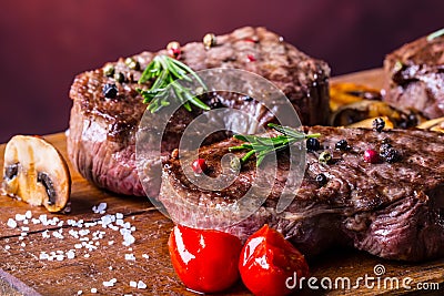 Grill beef steak. Portions thick beef juicy sirloin steaks on grill teflon pan or old wooden board Stock Photo