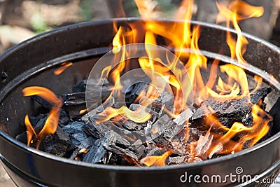 A grill with charcoal and flames Stock Photo