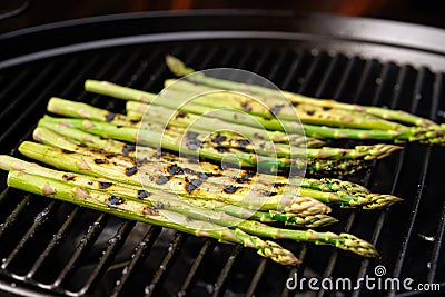 grill marks on asparagus stems in a grill wok Stock Photo