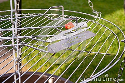 Grill tools on new chrome stell grate. Clean grate. Stock Photo