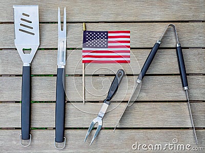 Grill tools on an outdoor table with an American flag Stock Photo