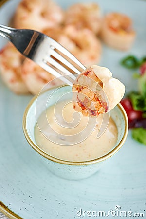 Grilled Argentine shrimp with mango-jalapeno sauce. Lunch in a restaurant, a woman eats delicious and healthy food Stock Photo