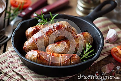 Grilled banges or sausages in a pan Stock Photo