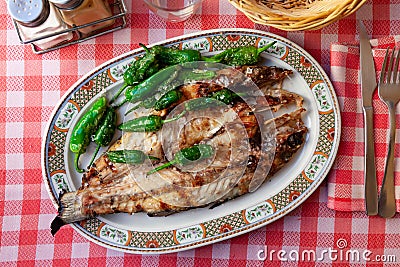 Grilled bass with Padron peppers Stock Photo