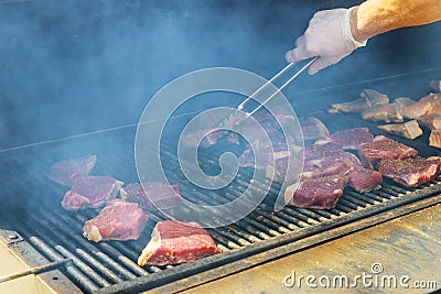 Juicy raw steaks grilling beef steak on the grill Stock Photo