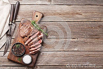 Grilled beef steak with spices on cutting board Stock Photo