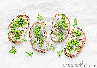 Grilled bread, soft cheese, green peas, radishes and micro greens spring sandwiches. Healthy eating, slimming, diet lifestyle conc Stock Photo