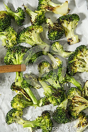 Grilled broccoli pieces on baking paper. Appetizer. Stock Photo