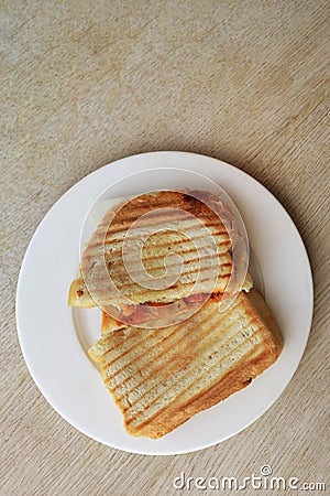 Grilled cheese sandwich for breakfast on rustic wooden table, top view Stock Photo