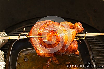 Grilled Chicken, bbq, over open flames in a barbecue Stock Photo