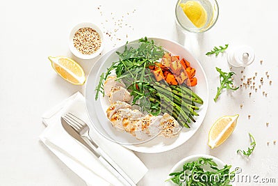 Grilled chicken breast, fillet with butternut squash or pumpkin, green beans and fresh arugula salad, healthy food, top view Stock Photo