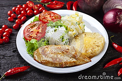 Grilled chicken breast fillet, rice, salad, potatoes pineapple slice Stock Photo