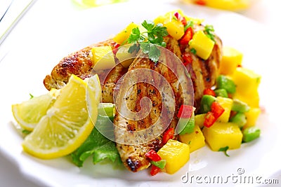 Grilled chicken breast with fresh mango salsa Stock Photo