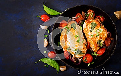 Grilled Chicken breast stuffed with tomatoes, garlic and basil in pan. Stock Photo