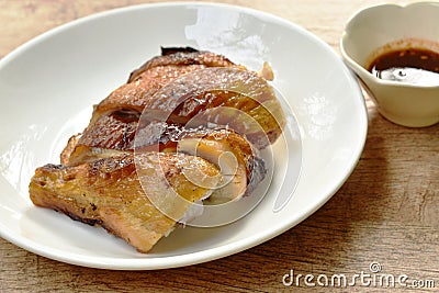 Grilled chicken cutting on plate dipping with spicy sauce Stock Photo