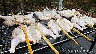 Grilled chicken with iron preparations on the iron grill smoke a lot, Food in thailand Stock Photo