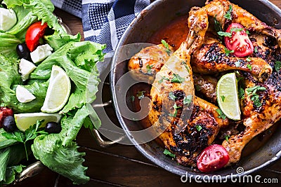 Grilled chicken legs, lettuce and cherry tomatoes limet olives. Traditional cuisine. Mediterranean cuisine Stock Photo