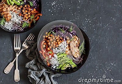 Grilled chicken, rice, spicy chickpeas, avocado, cabbage, pepper buddha bowl on dark background, top view. Stock Photo