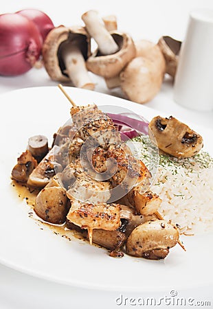 Grilled chicken skewer with mushrooms and rice Stock Photo