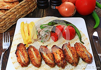 Grilled chicken wings with garnish on wooden Stock Photo