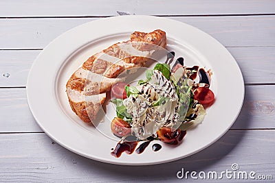 Grilled chiken fillet. Raw vegetables, wooden background Stock Photo