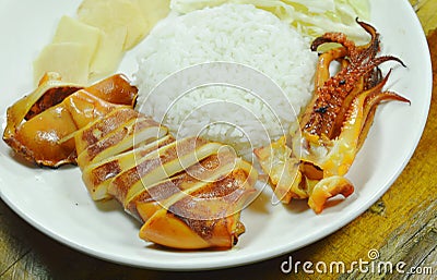 Grilled cuttlefish with rice topping slice cabbage and ginger on plate Stock Photo