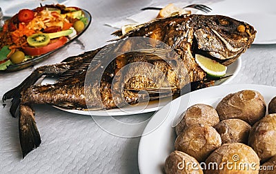 Grilled fish and canarian potatoes in Canary islands Stock Photo