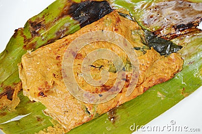 Grilled flower crab with curry paste in banana leaf on plate Stock Photo