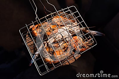 Grilled flower crabs and shrimps on charcoal stove camping at campfire Stock Photo