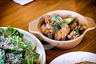 Grilled Gambas al Ajillo, Spanish chilli-and-garlic shrimp, served on a wooden table Stock Photo